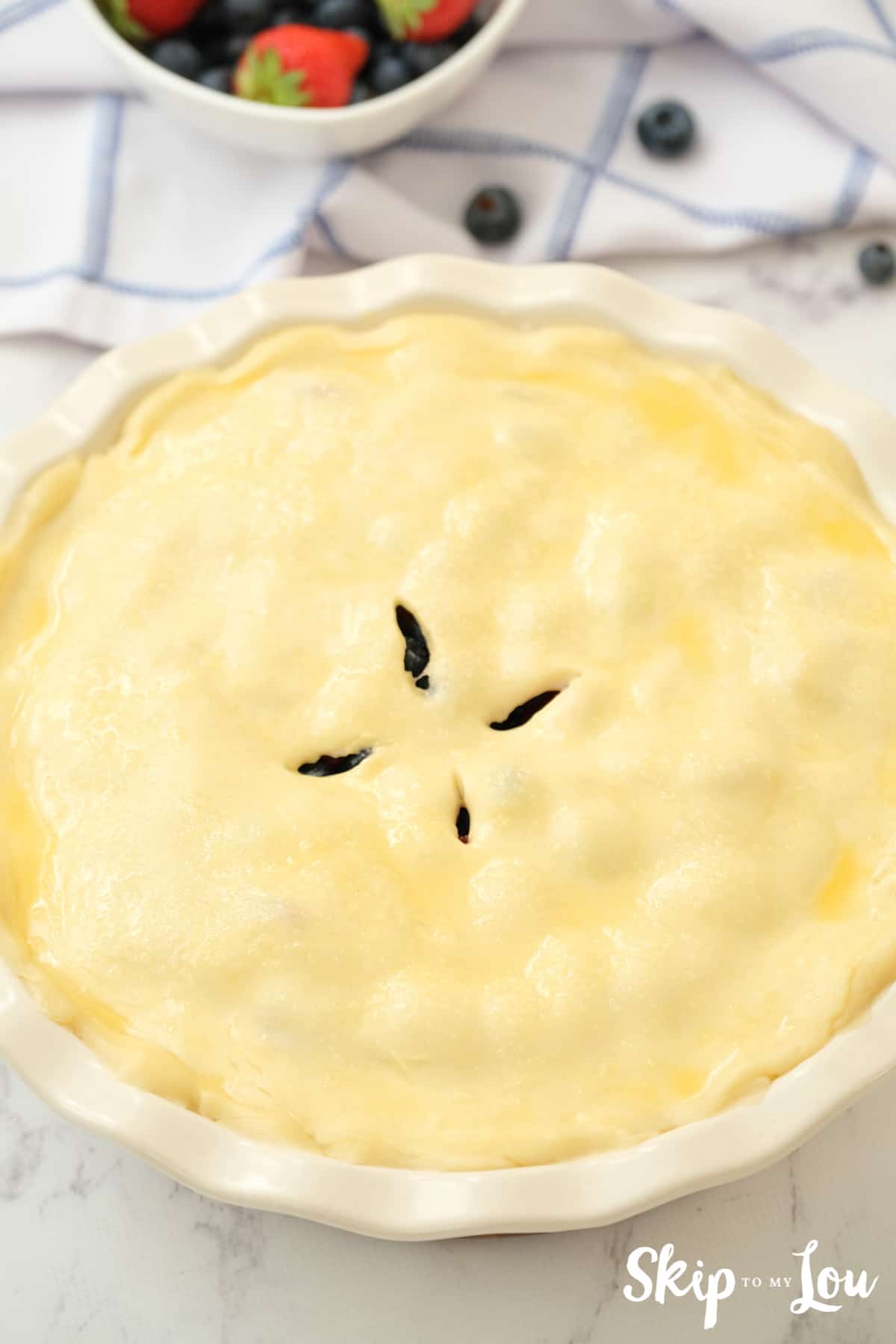 Top of pie crust brushed with butter ready to bake.