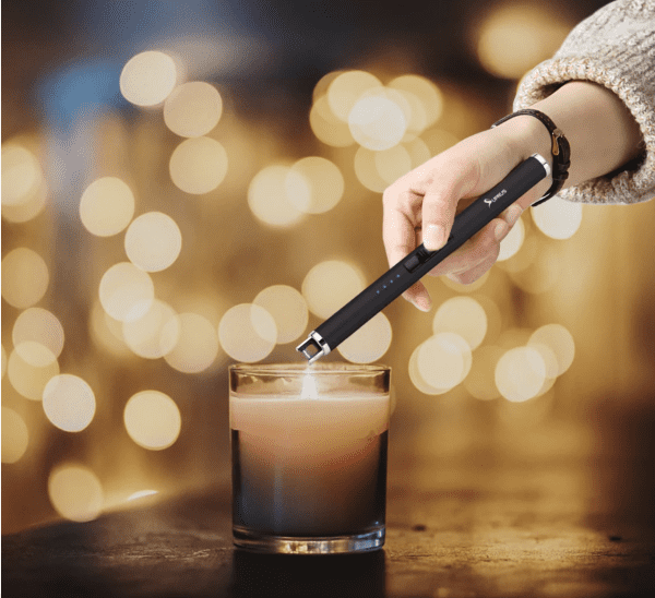 electric lighter lighting a candle
