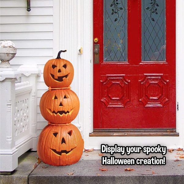 Carved pumpkins stacked to display on the porch.