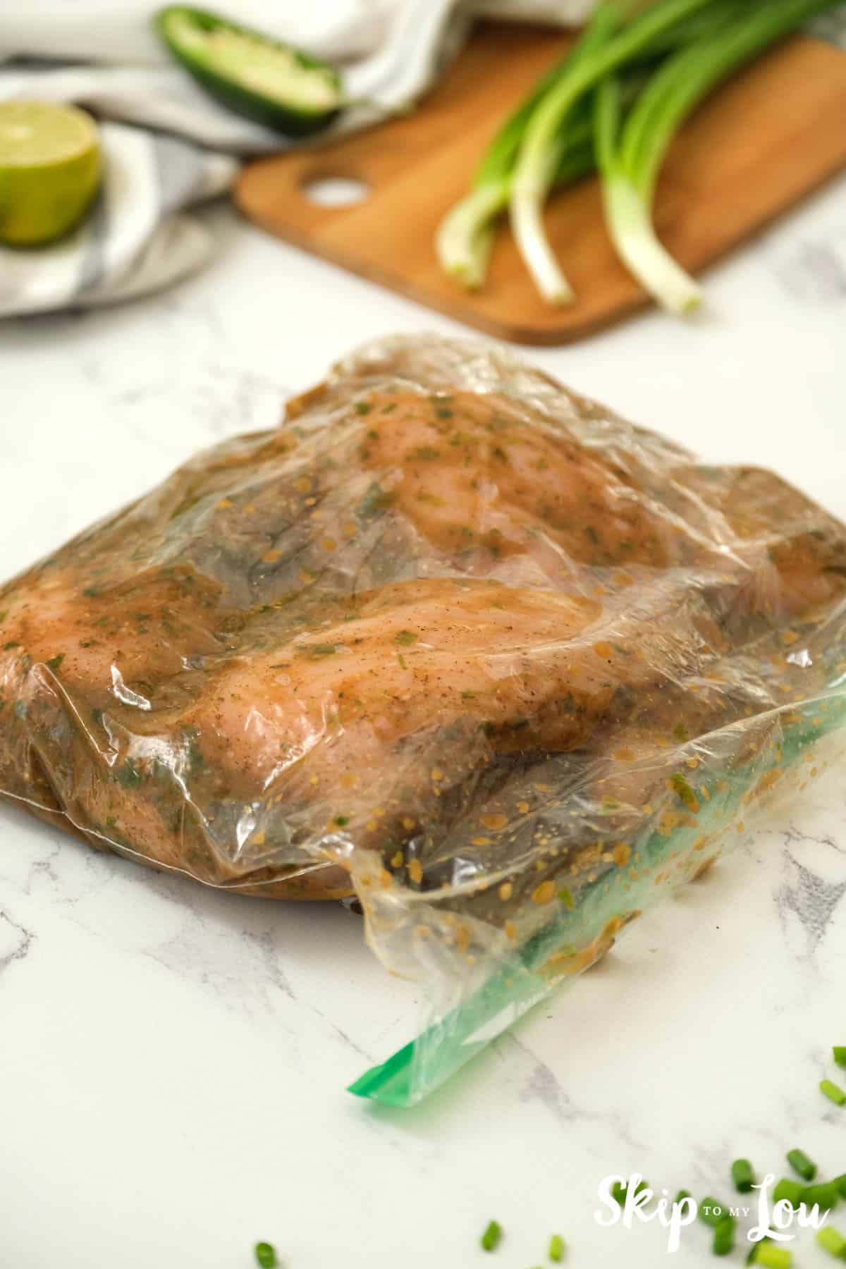Chicken in a zip-lock bag with the marinade for the Jerk Chicken Recipe. -Skip To My Lou