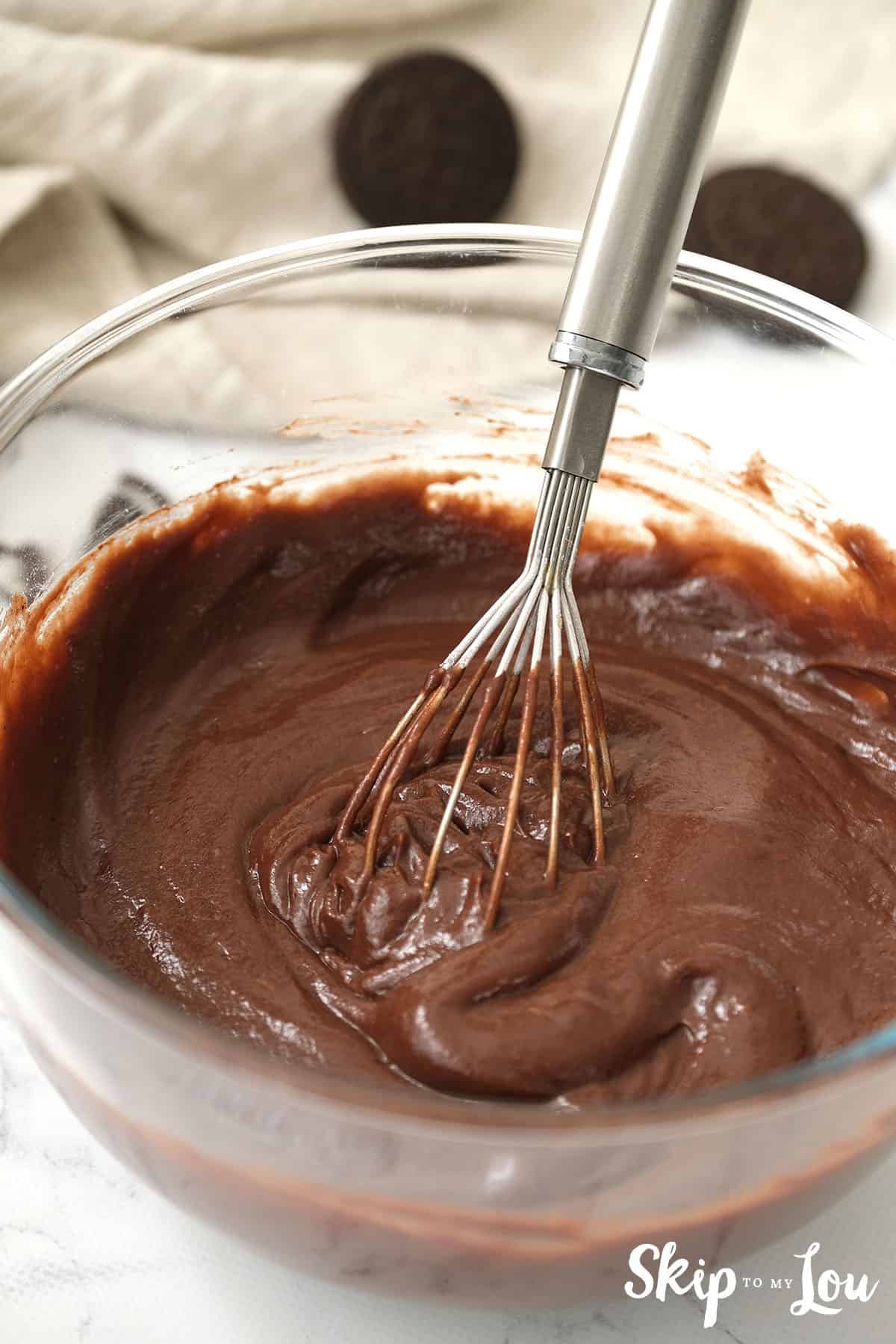 The pudding mix and milk in a bowl being whisked for the Oreo Pie.