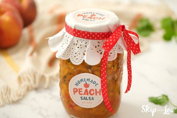 Peach salsa complete with lace top tied with a red reibbon with white polka dots. 