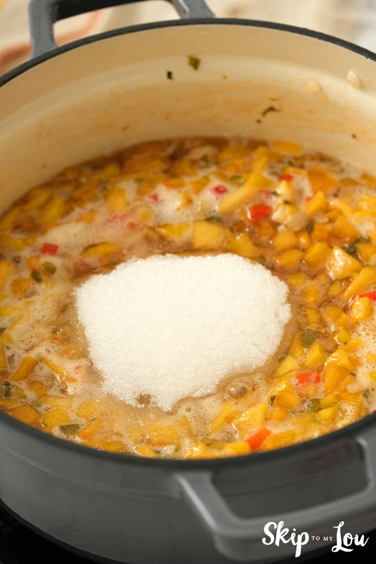 Peach salsa boiled in a large pan with the last ingredient, sugar added for the Peach Salsa.