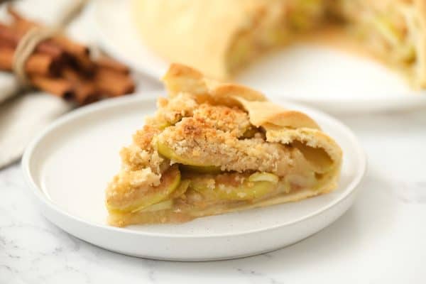 Slice of Rustic Apple Pie served on a white dish.
