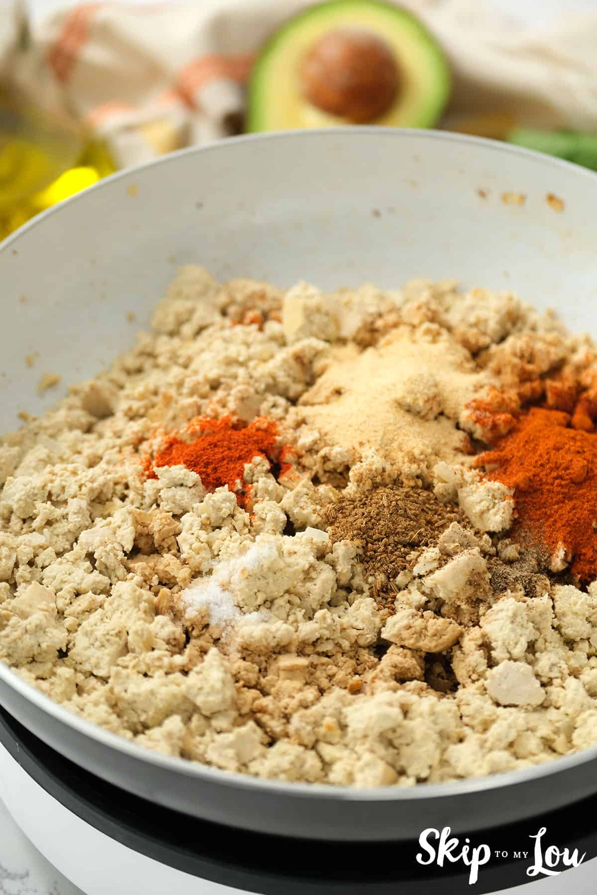 Spices added to the large pan with the tofu and onions for the sofritas bowl.