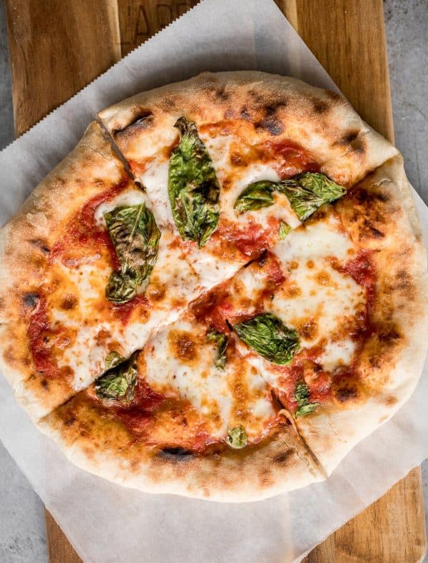 Image shows a homemade pizza made with sourdough excess.