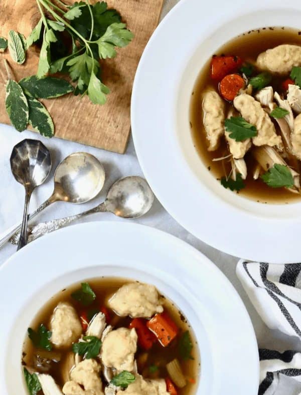 Image shows a chicken and sourdough dumplings on a plate.