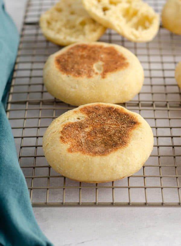 Image shows a picture of three english muffins made with sourdough