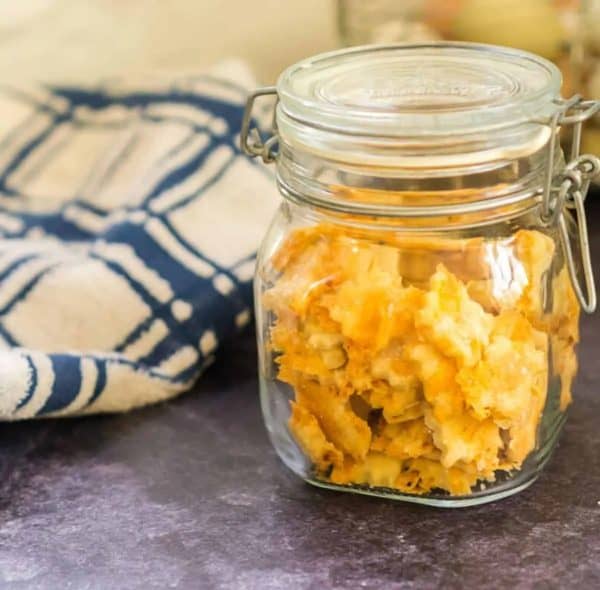 Image shows a mason jar with cheddar crackers made with sourdough.