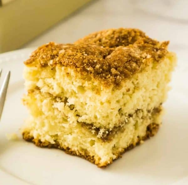 Image shows a slice of a sourdough coffee cake with cinnamon streusel topping