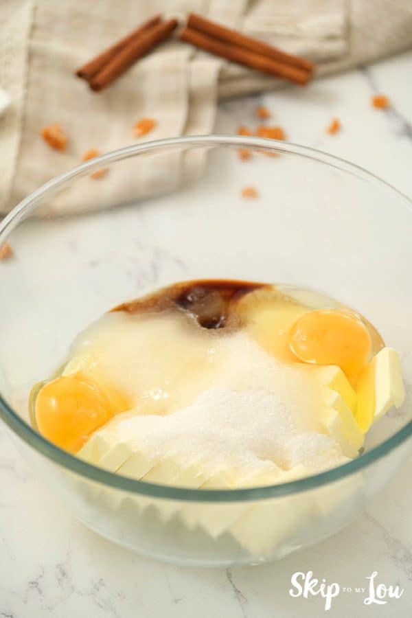 A glass mixing bowl with sugar, butter, shortening, eggs, and vanilla for making Toffee Doodle Cookies. -Skip To My Lou