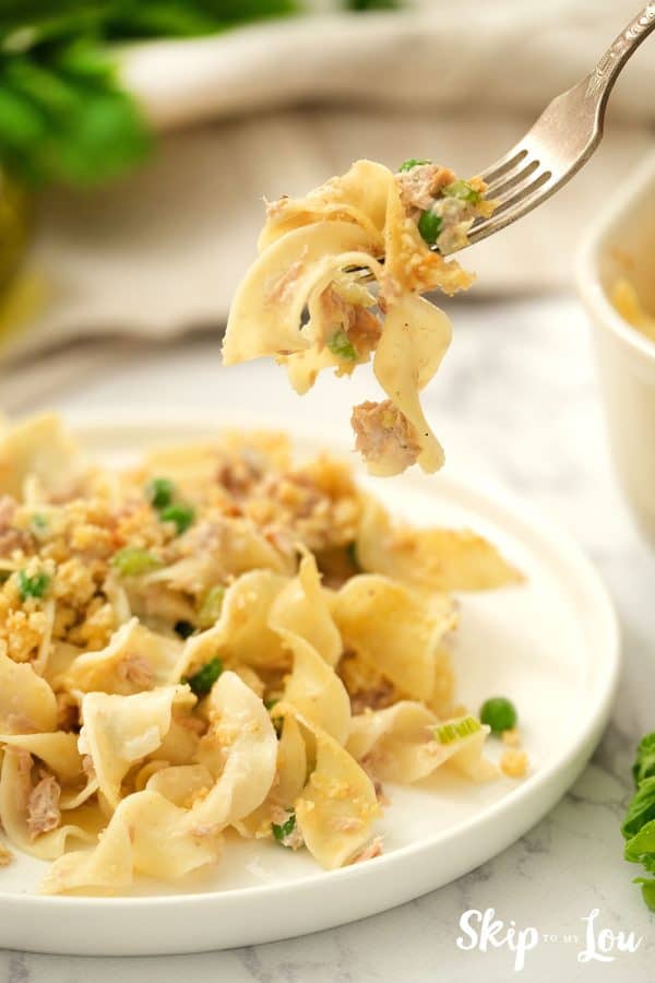 Tuna Noodle Casserole served on a white dish with a bite on a fork.