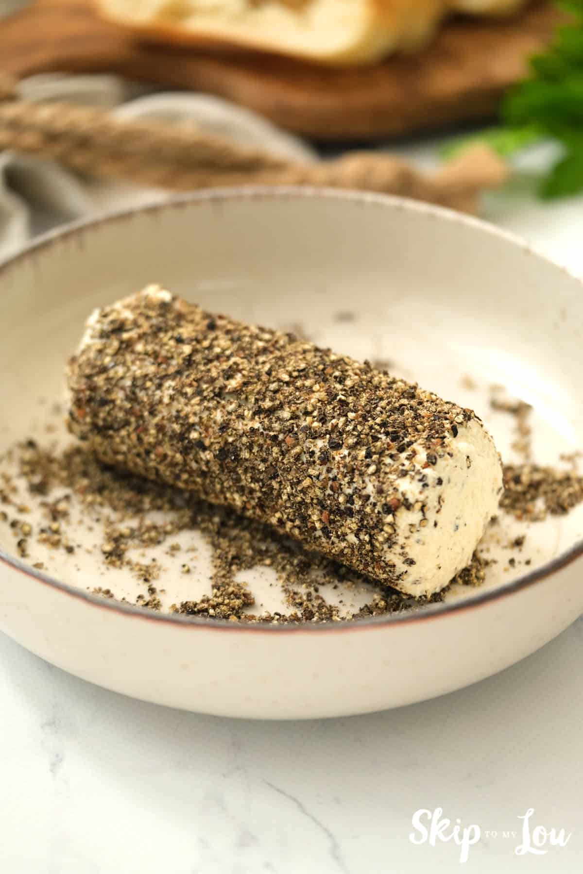 Herb butter spread log in a dish rolled in crushed pepper. Skip To My Lou