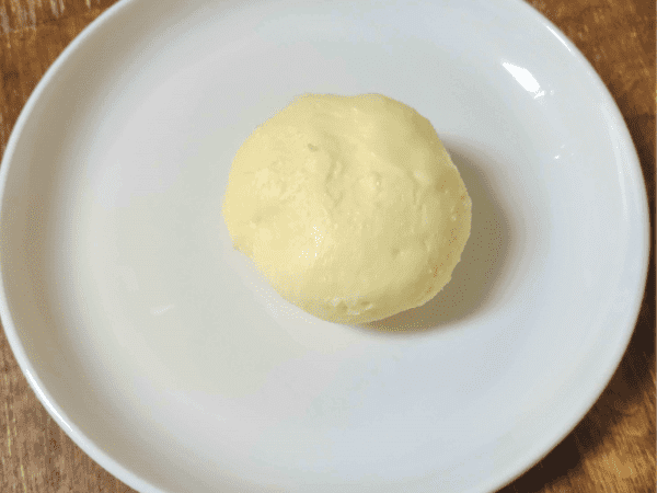 pat of homemade butter on a white plate