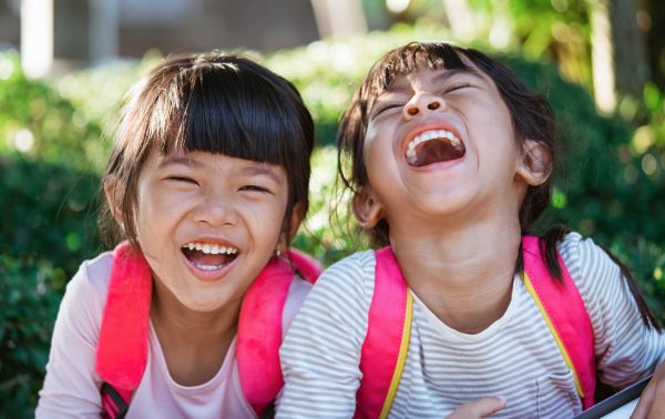 skip to my lou image of two elementary school children laughing at kids jokes