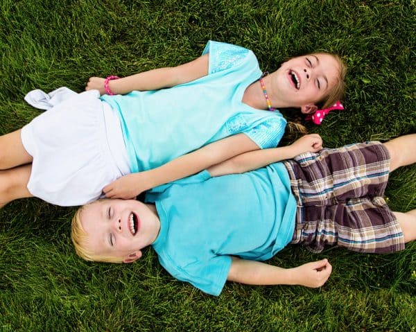 skip to my lou image of top view boy and girl kids laughing at kids jokes