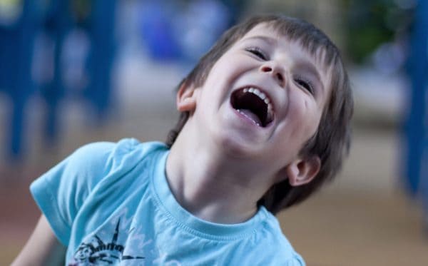 skip to my lou image of a young boy outside laughing at kids jokes