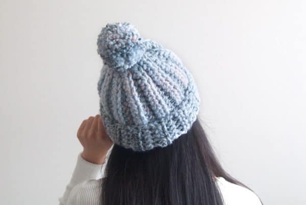 girl wearing gray beanie on white background skip to my lou