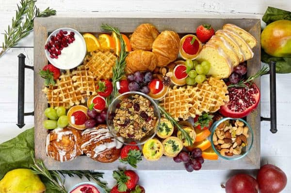 Image shows a charcuterie that also includes desserts like waffles. via 31 daily