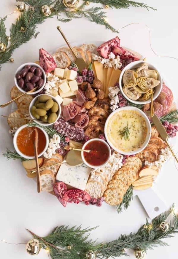 Image shows a charcuterie board with cheeses, meats, dips and olives. From Amanda wilens