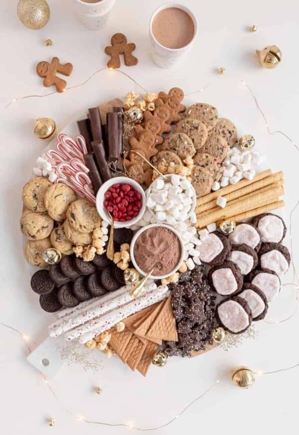 Image shows a chocolate board with chocolate cookies, candy canes, gingerbread men cookies, etc. from amanda wilens