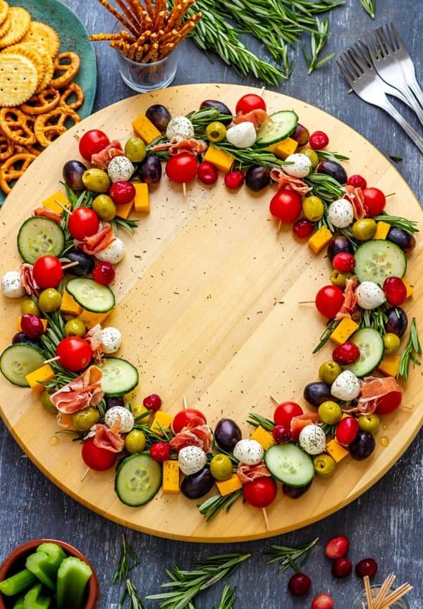 Image shows a cheese charcuterie board shaped like a christmas wreath. from appetizer addiction