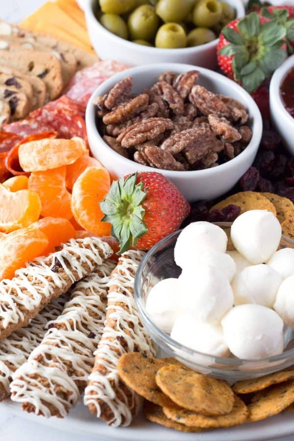 Image shows a sweet and salty board for the holidays, with nuts, fruits, cookies, salami and more. From Borrowed Bites