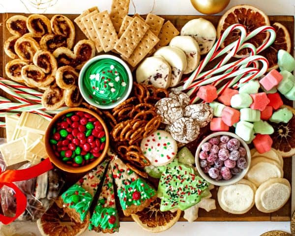 Image shows a dessert board with a Christmas theme - cookies, cakes, sweets and crackers. From Chenee today