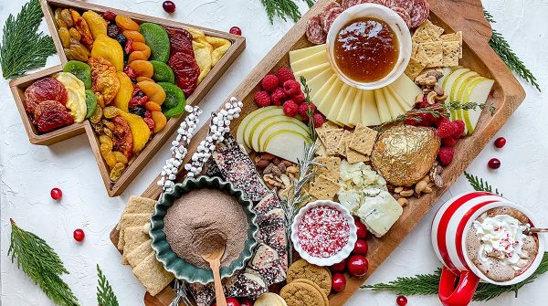 Image shows a charcuterie board and a died fruit board from the table