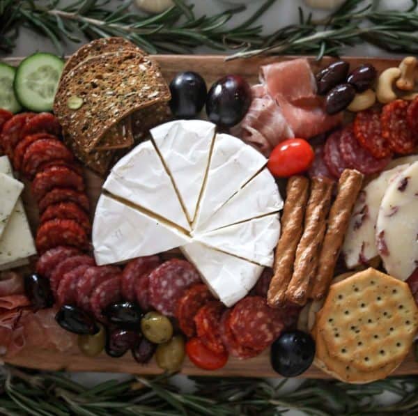Image shows a charcuterie board with cheeses and meats, from Kim Schob