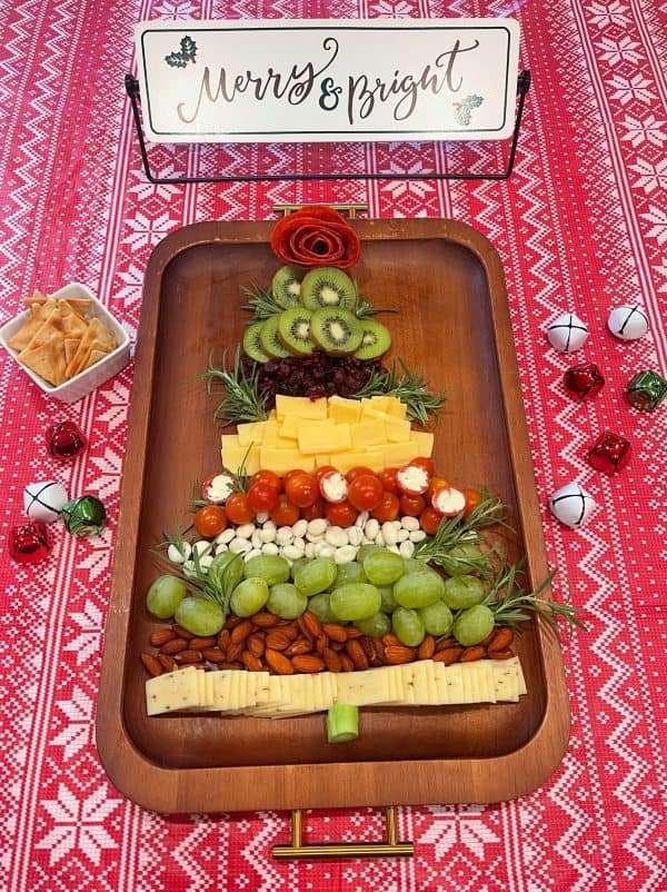 Image shows a charcuterie board with cheese, fruits, nuts and cheeses. From More with less today
