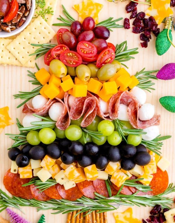 Image shows a charcuterie board with fruits and vegetables too, arranged to look like a Christmas tree. via sweet tea + sprinkles