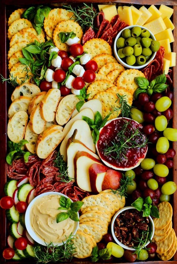 Image shows a charcuterie board with bread, crackers, and fruits and jelly. From The Anthony Kitchen