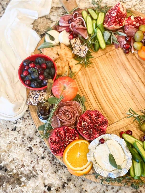 Image shows a carcuterie board with fruits and cheese, shaped like a wreath. via this vivacious life