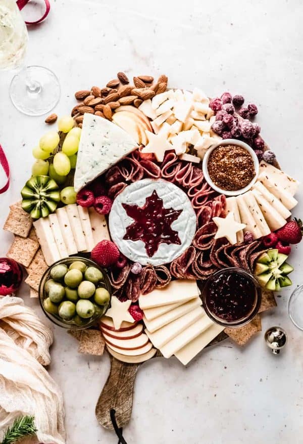 Image shows a cheese board with a Christmas theme. via winter city dinner fairy