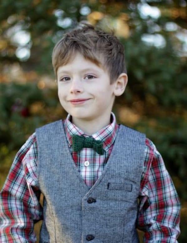 green crochet bow tie on little boy with plaid shirt and gray vest