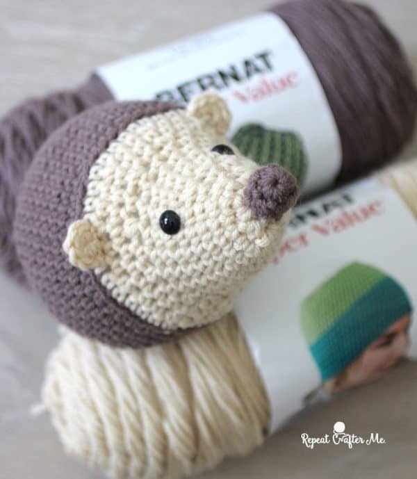 crochet hedge hog toy on two colors of yarn.