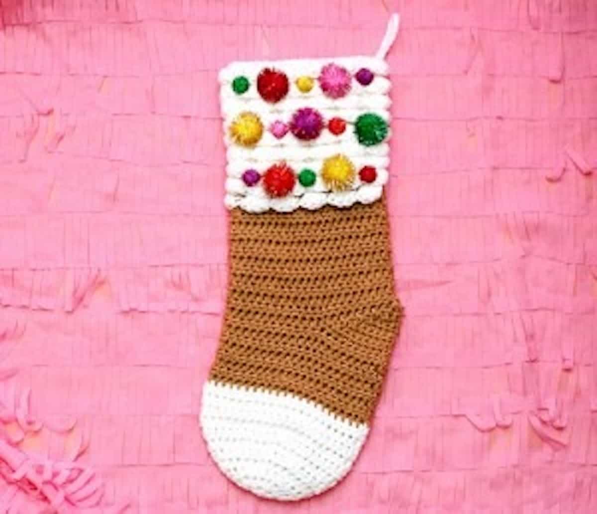 crochet gingerbread stocking on pink background