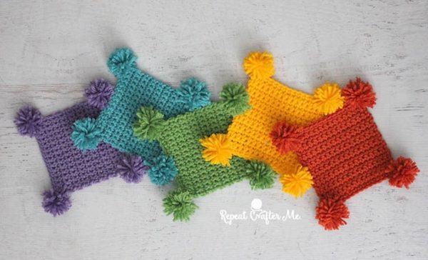 pom pom coasters on white background skip to my lou