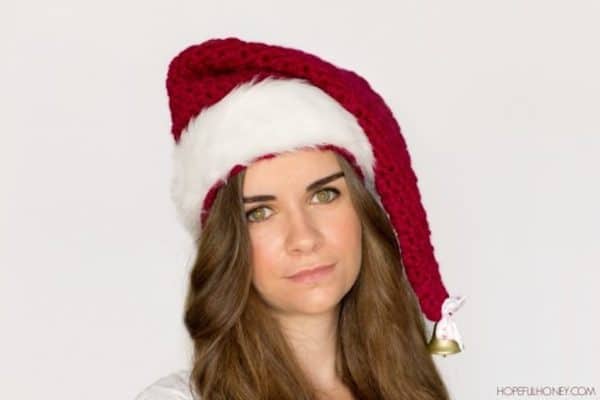 Girl in Santa hat on white background skip to my lou