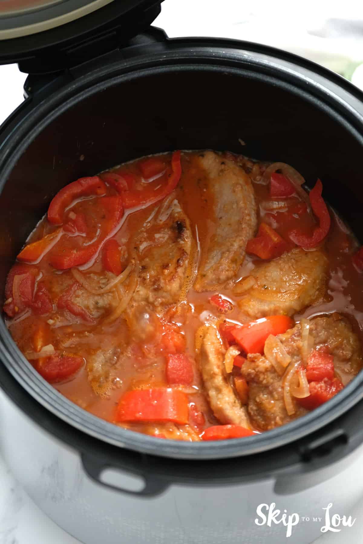 Added to the instant pot is the tomato paste, tomatoes, smoked paprika, oregano, Worcestershire sauce, steak, and beef broth and stir to combine for the Swiss Steak. -Skip To My Lou
