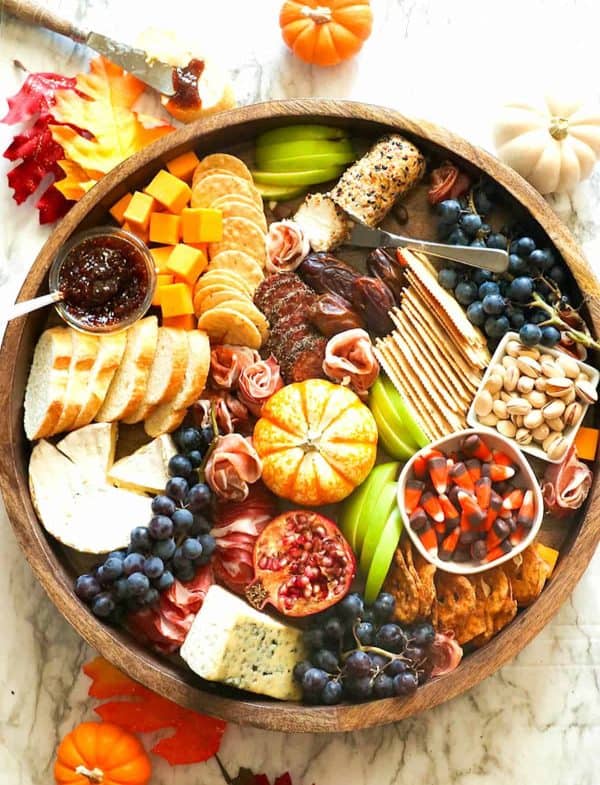 Image shows a thanksgiving charcuterie board with fall flavos.