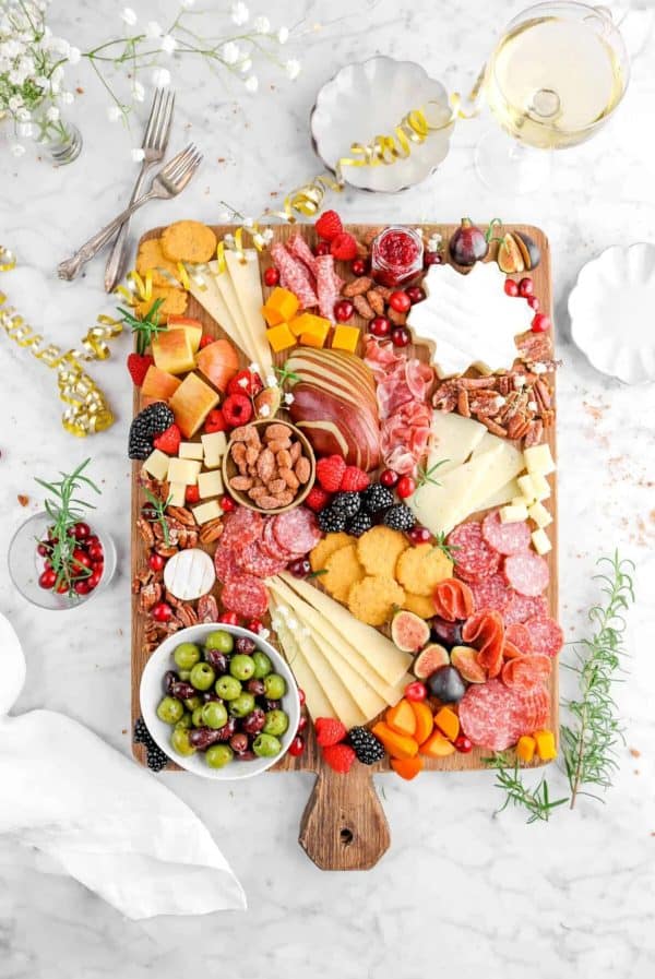 Image shows a holiday charcuterie board with decorations.