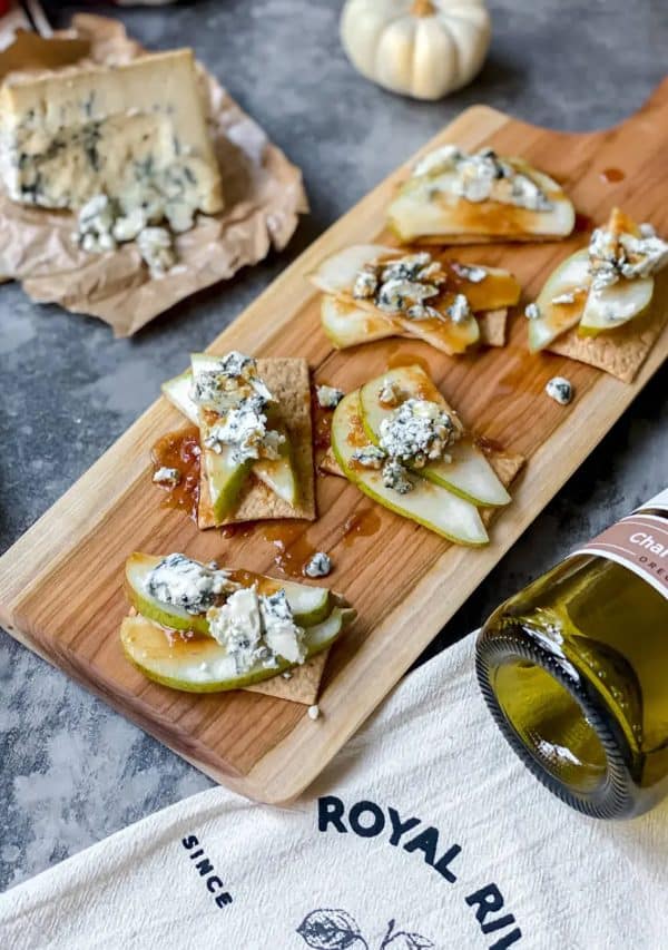 Image hsows an elegant charcuterie board with a Thanksgiving theme.