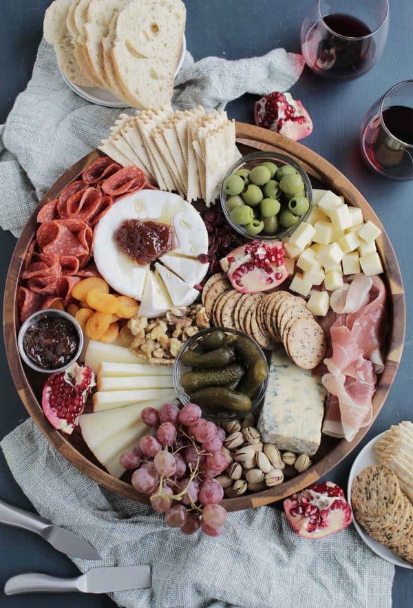 Image shows a Thanksgiving themed charcuterie board with cheese and hams.