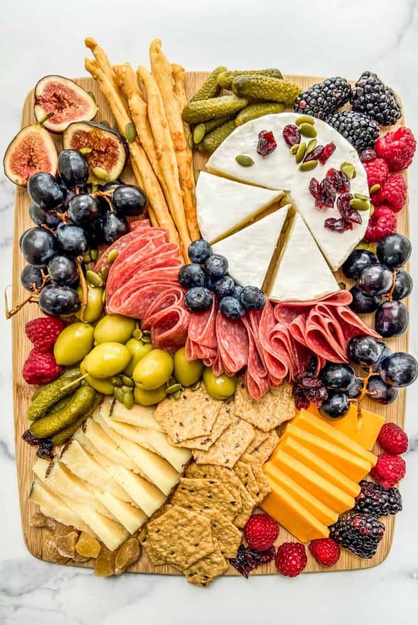 Image shows a Fall charcuterie board with cheese and hams.