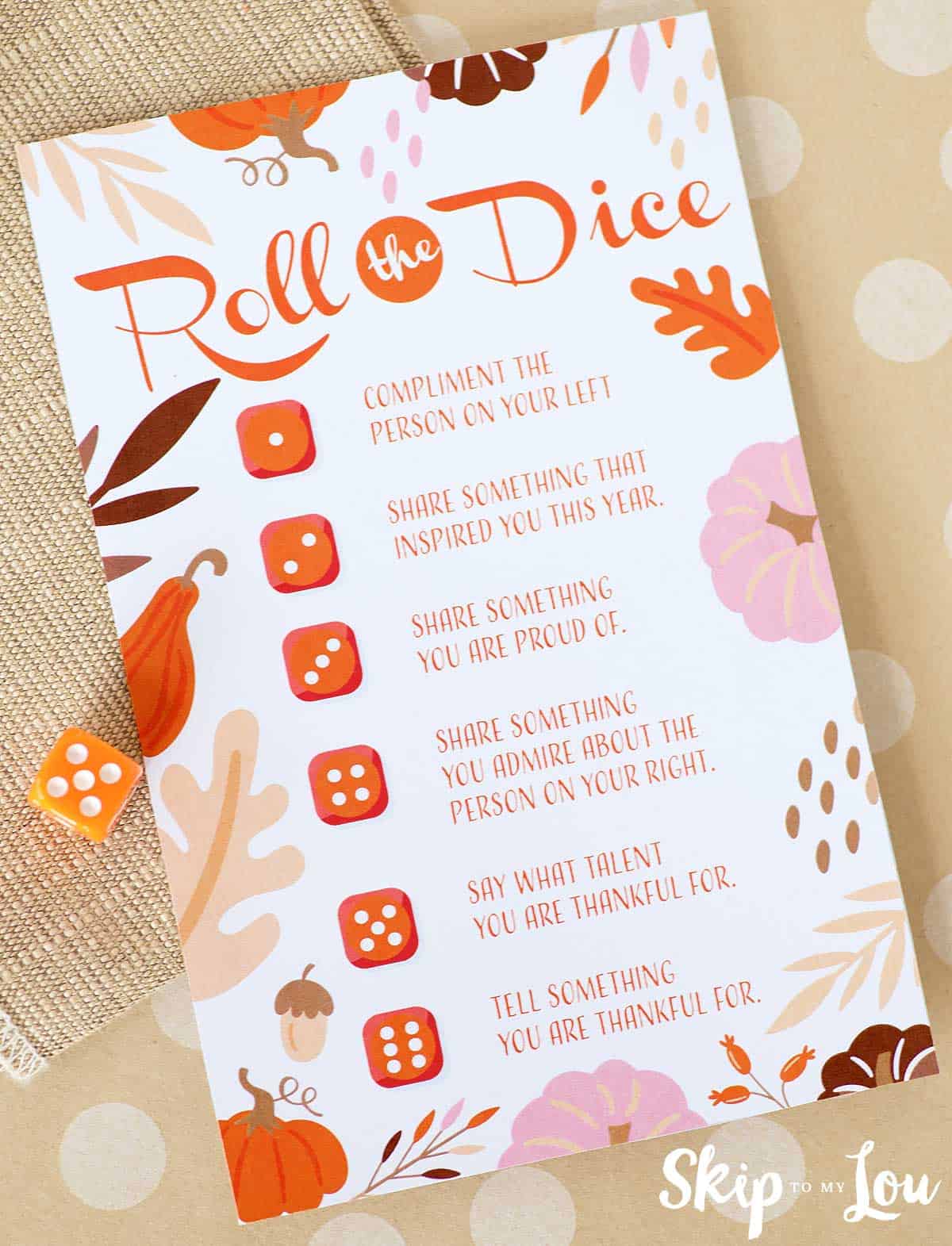 Image shows a printable Roll the dice game with instructions and Autumn decorations.