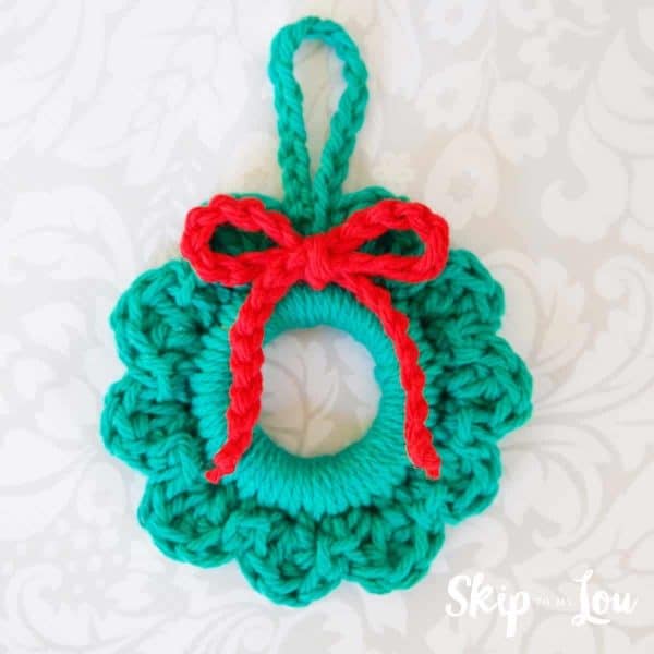 Christmas wreath ornament on white table cloth skip to my lou
