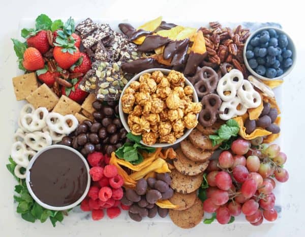 Image shows a dessert board with cookies, fruits, nuts, pretzels and popcorn. from boston girl bakes