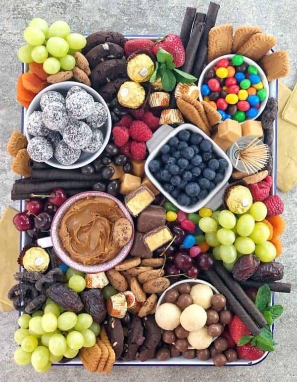 Image shows a dessert platter with chocolates, fruits, cookies and dried fruits. via chef not required